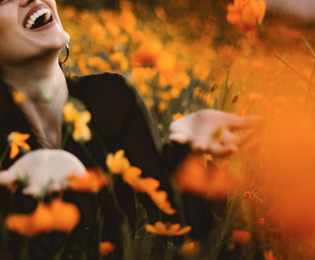 Woman looking happy in field of flowers