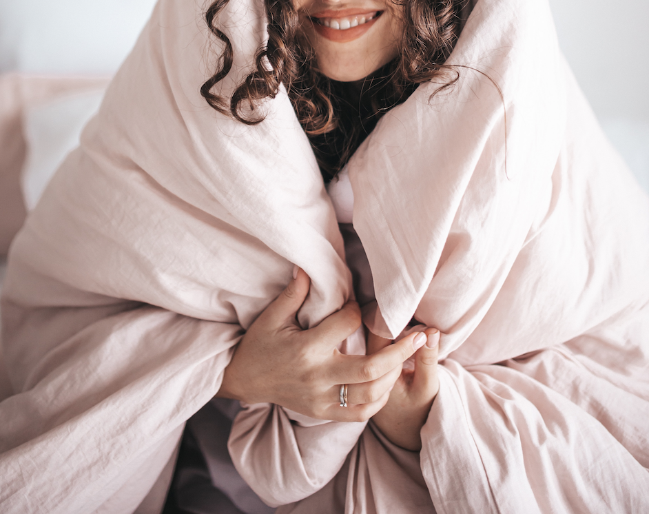 a woman wrapped in a blanket giving herself permission to care for herself