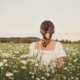 a woman in a field of flowers overcoming feelings of vulnerability