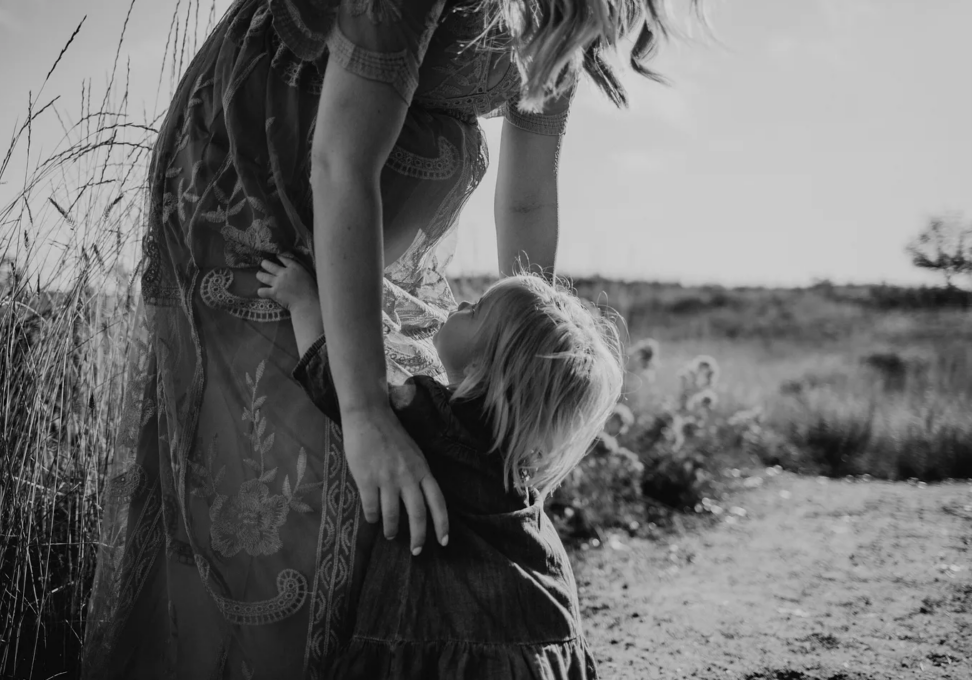 woman pausing with hand on heart reflecting on what she needs