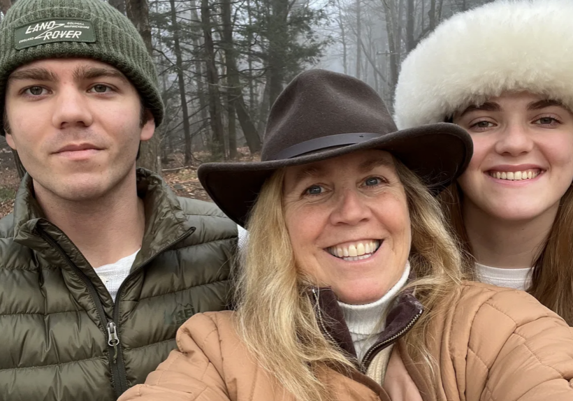 mother walking outdoors with her two adult children on a winter day